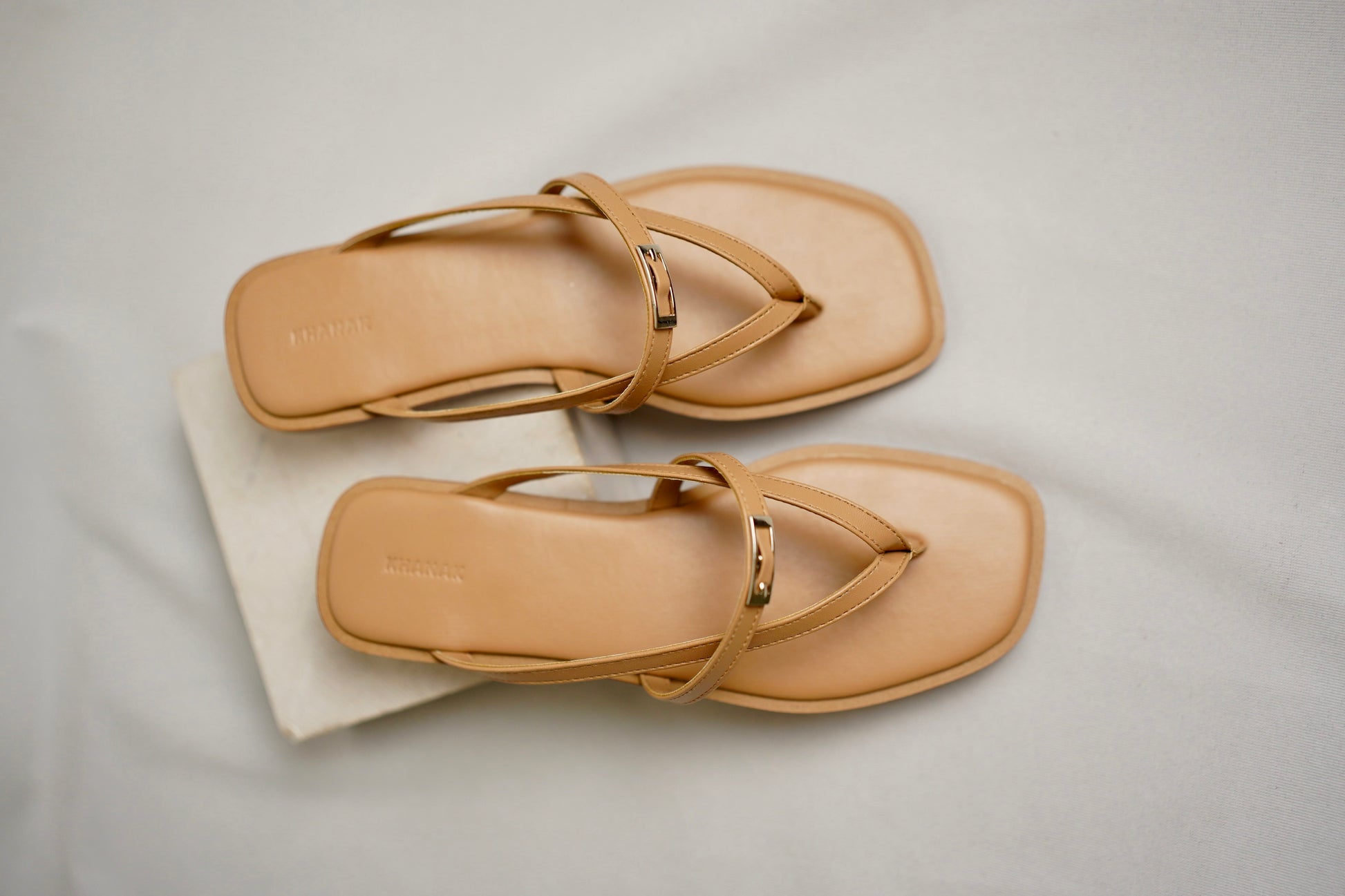 Nova beige flat sandals with cushioned footbed and embossed Khanak logo